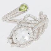 Oval green peridot and moissanite sterling silver ring showcasing intricate design and elegant sparkle.